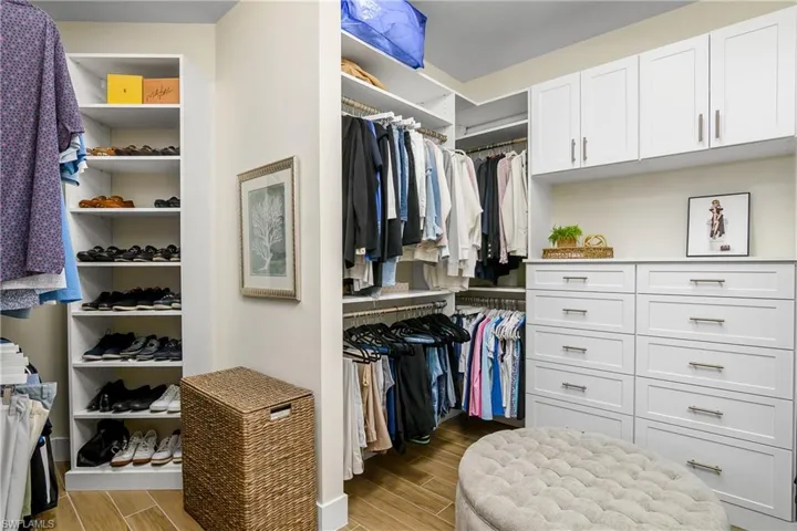 Plenty of storage in the owner closet with custom built in cabinets and shelves.