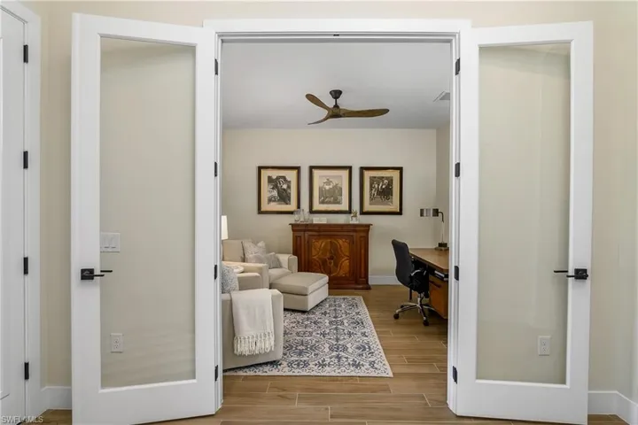 French doors leading into den/flex room, located just off the home's entry foyer.