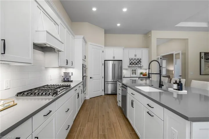 Kitchen also includes a beverage service area with wine rack and wine cooler.
