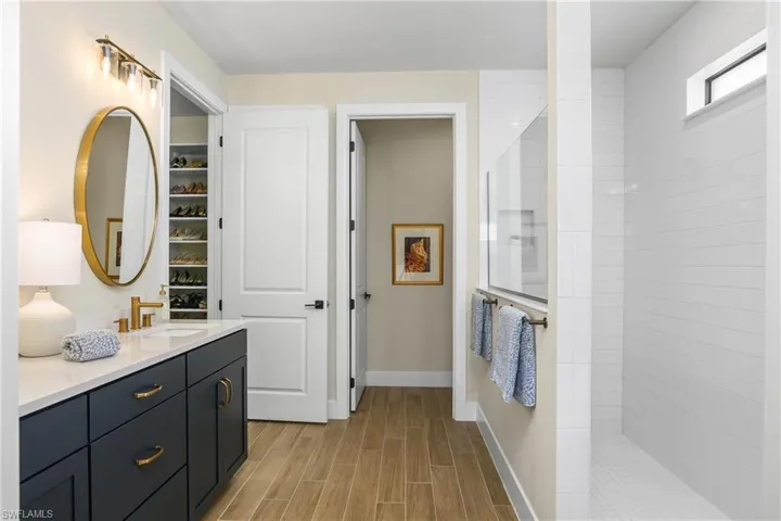Owner Suite with oversized walk-in shower with frameless glass enclosure.