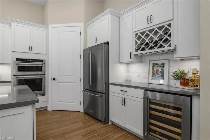 Beverage service area with wine rack and wine cooler.