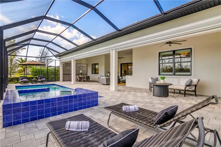Note the extended covered outdoor space which spans the entire length of the home and is accented by remote storm shades.