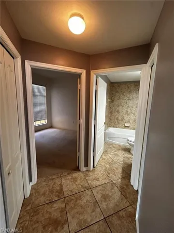 Hall featuring tile patterned flooring