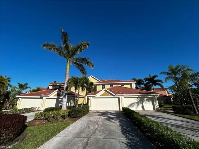 View of front facade featuring driveway and a garage