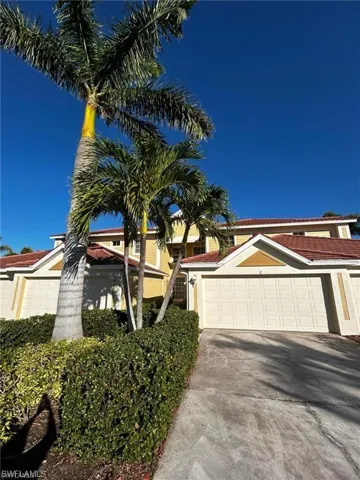 View of front of home featuring concrete driveway, an attached garage, and stucco siding