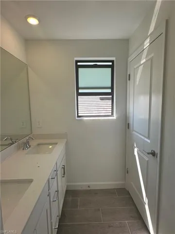 Bathroom with tile floors and double sink vanity