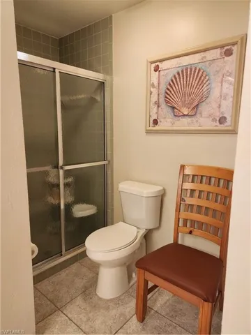 Full bathroom with a shower stall and light tile patterned floors