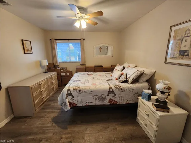 Bedroom featuring a ceiling fan and dark wood-style flooring
