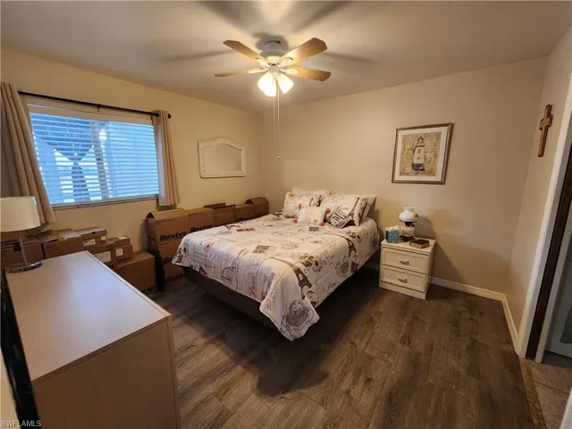 Bedroom featuring dark wood-style floors and a ceiling fan
