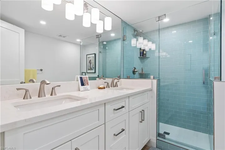Bathroom featuring vanity and a shower with shower door