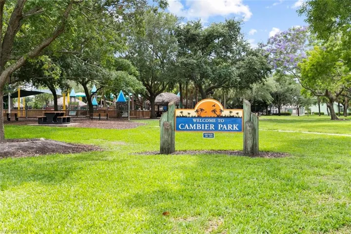 View of property's community with a lawn