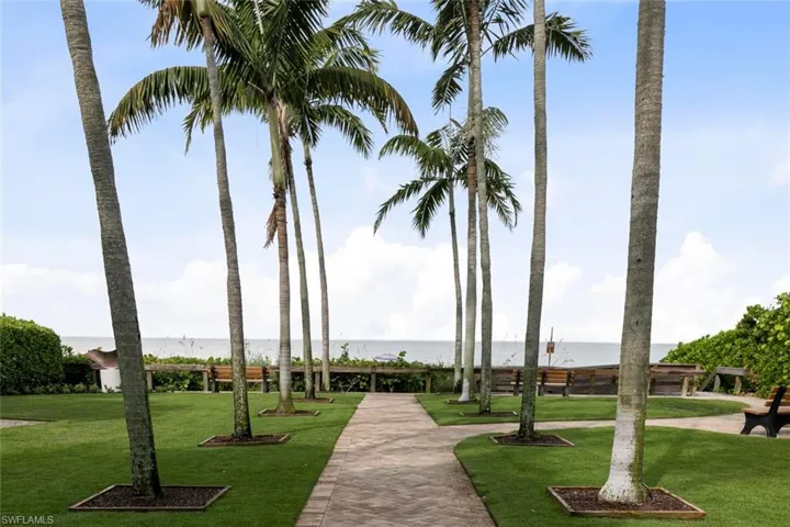 Surrounding community featuring a lawn and a water view
