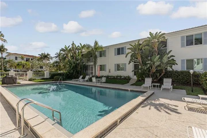 Community pool with fence and a patio