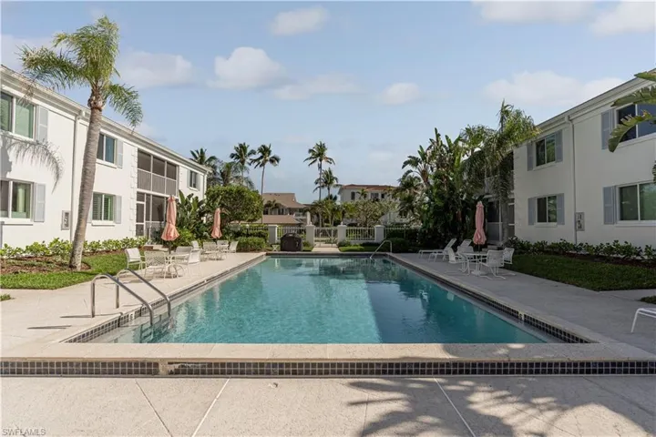 Pool with a residential view, fence, and a patio area