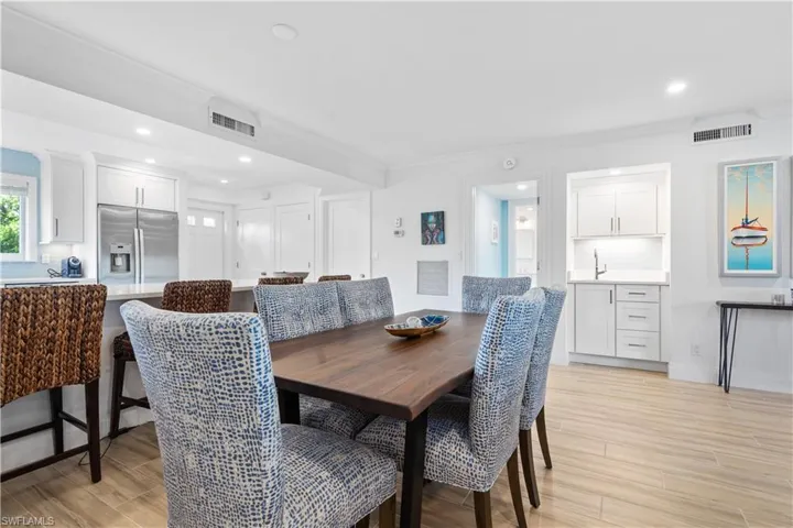 Dining room with light hardwood / wood-style flooring and crown molding
