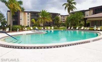 Community pool with a patio