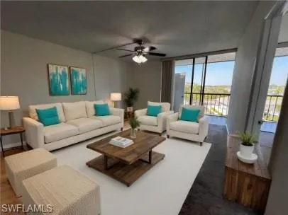 Living area with a ceiling fan and expansive windows