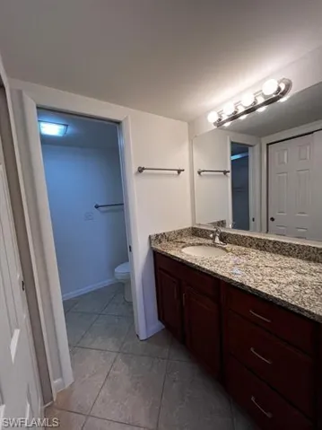 Bathroom with vanity and light tile patterned flooring