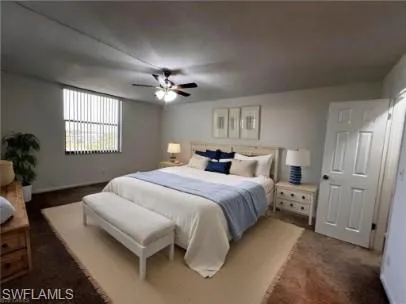 Bedroom with a ceiling fan and dark carpet