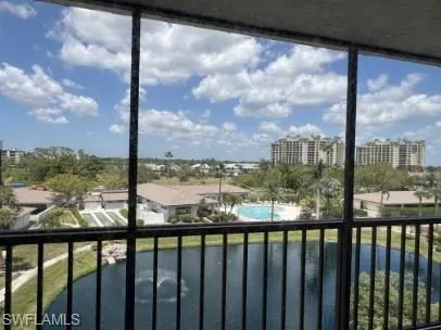 Balcony with view of pool and a sunroom