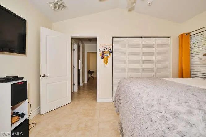 Bedroom with vaulted ceiling and ceiling fan