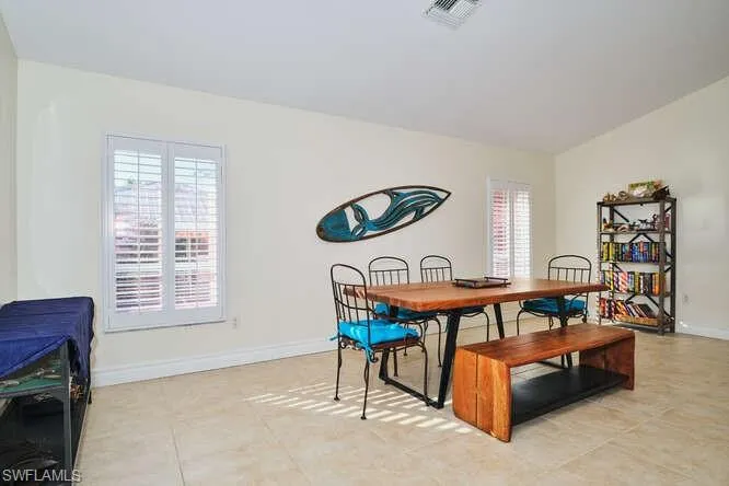 Dining space featuring lofted ceiling and baseboards