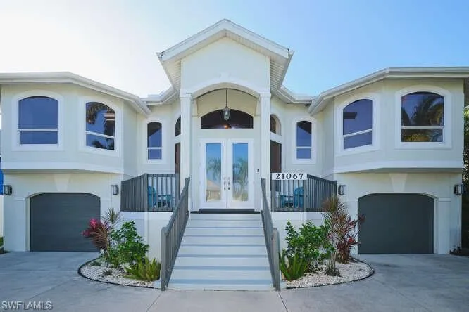 View of front of property featuring french doors, stucco siding, and a garage