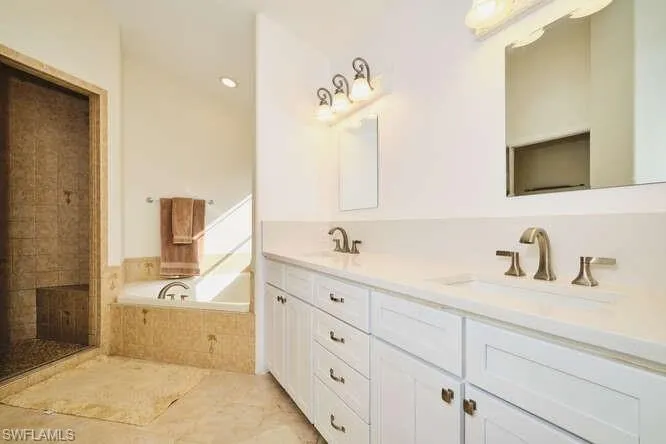 Bedroom featuring lofted ceiling, ceiling fan, and connected bathroom