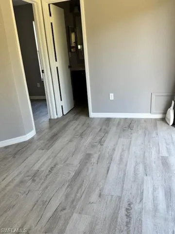 Empty room featuring light wood-type flooring and baseboards