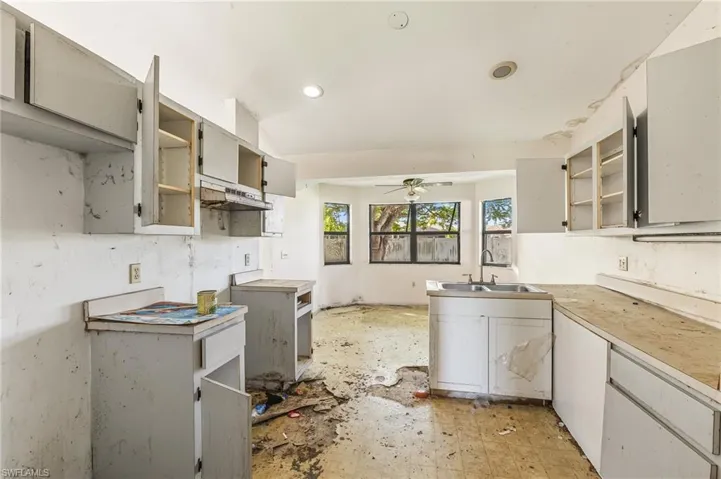 Kitchen with open shelves, a ceiling fan, light countertops, under cabinet range hood, and recessed lighting