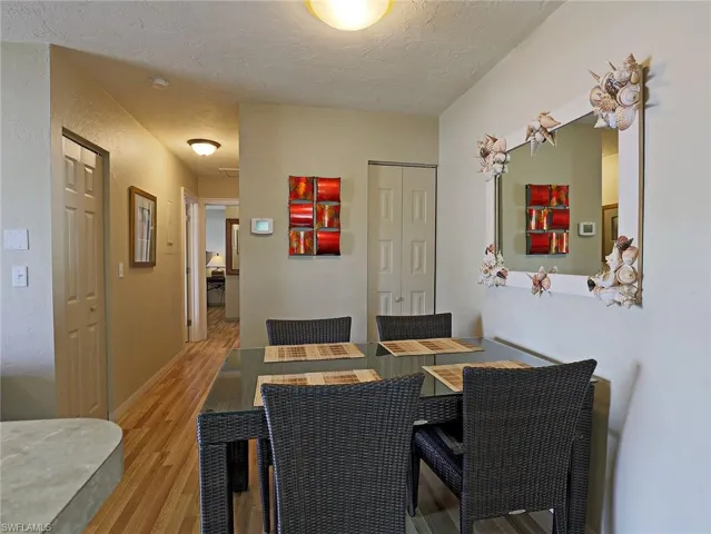 Dining area featuring light wood-style floors and a textured ceiling