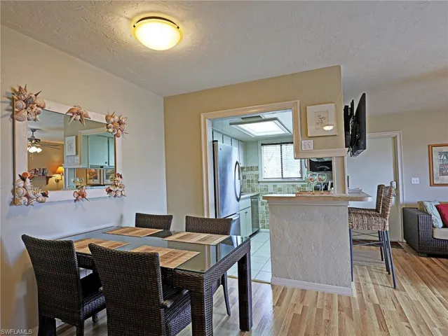 Dining space with light wood-type flooring and a textured ceiling