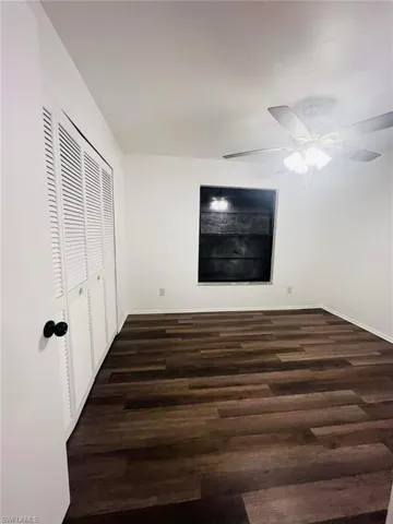 Wood-finish flooring throughout, complemented by a ceiling fan with integrated lighting