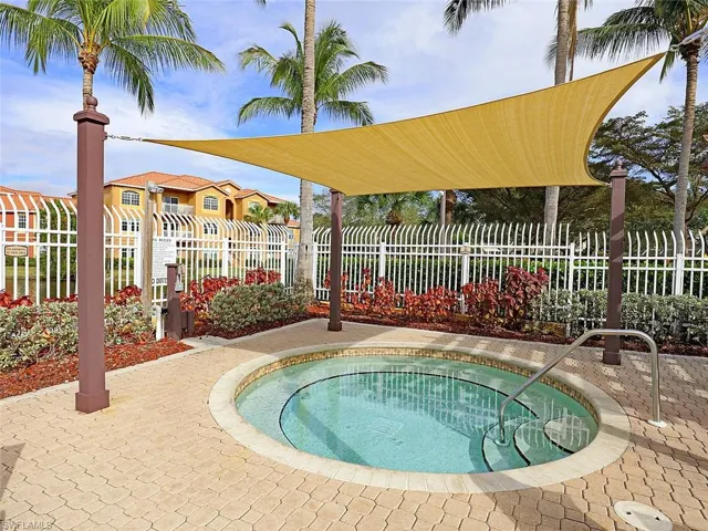 View of pool with a community hot tub