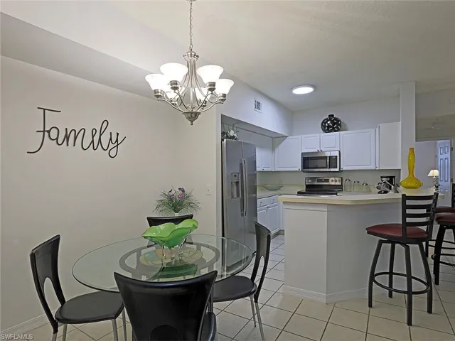 Dining area featuring a chandelier and light tile patterned flooring