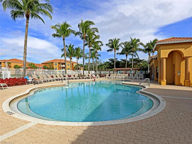 Community pool with a patio