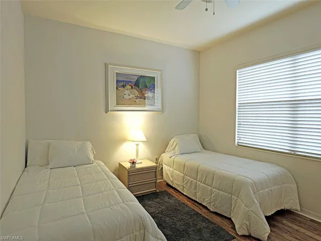 Bedroom with wood finished floors and ceiling fan