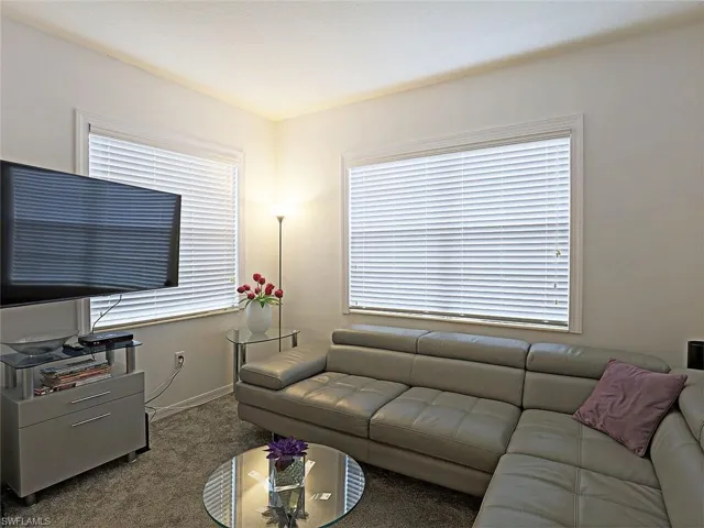 Living area with carpet and baseboards