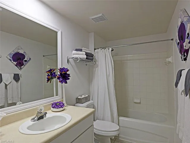 Full bath featuring vanity and shower / tub combo with curtain