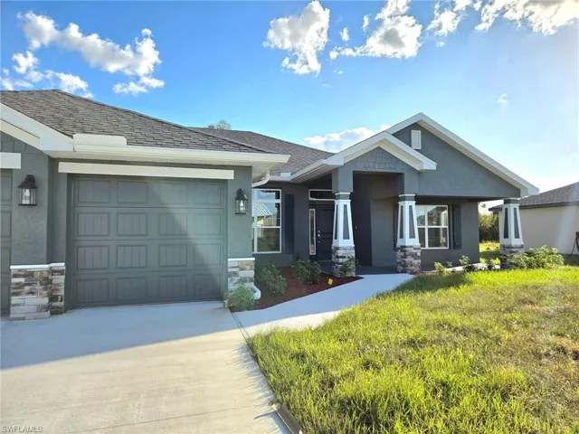 View of front of house with a front lawn and a garage