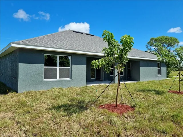 Back of property with a yard
