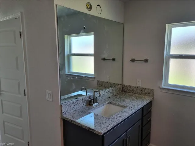 Bathroom featuring vanity and a healthy amount of sunlight