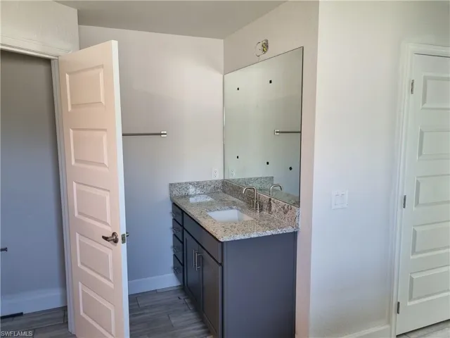 Bathroom featuring vanity and hardwood / wood-style floors