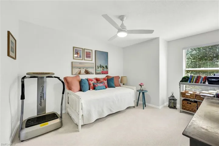 Bedroom with light colored carpet and ceiling fan