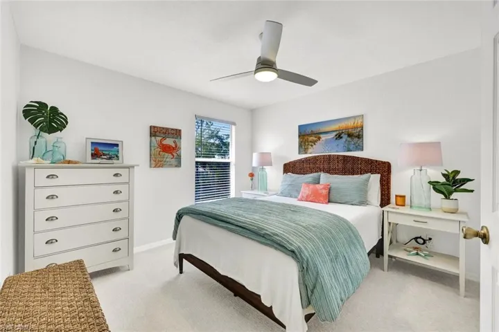 Bedroom with light colored carpet and ceiling fan