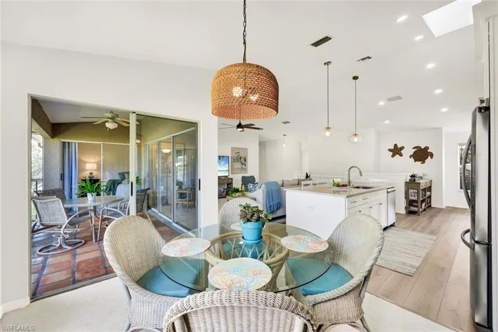 Dining area with vaulted ceiling, a ceiling fan, and recessed lighting