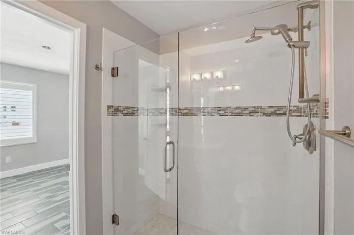 Bathroom with a stall shower and baseboards- Virtually Enhanced
