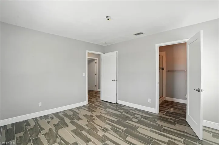 Unfurnished bedroom featuring baseboards- Virtually Enhanced