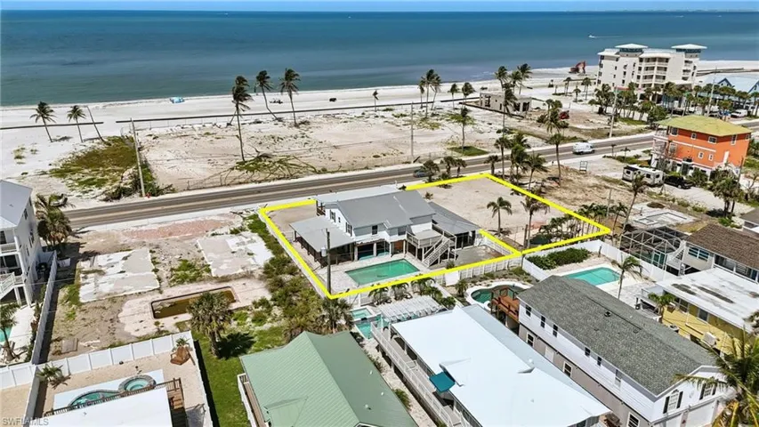 Aerial view of property's location with property parcel outlined and waterfront with a beach neighboring lot can be included in bundle or separately purchased- Virtually Enhanced