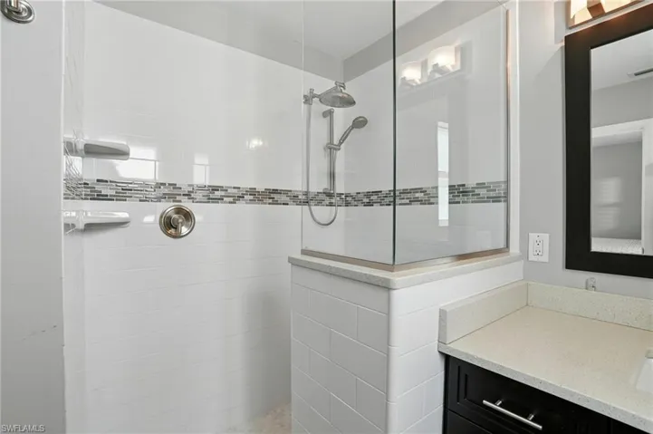 Full bath featuring walk in shower and vanity- Virtually Enhanced